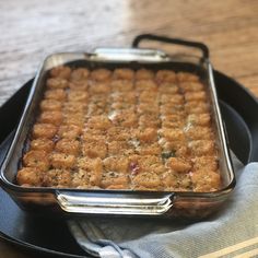 a casserole dish is sitting on a plate with a napkin next to it