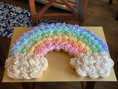 a rainbow cake sitting on top of a table