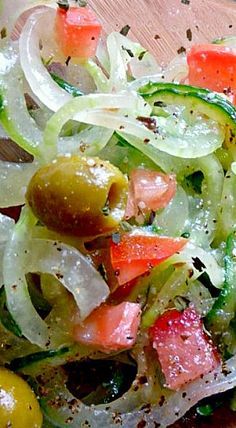 a salad with onions, olives and other vegetables