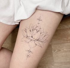 a woman's leg with a flower tattoo on it