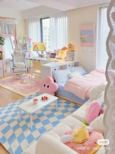 a room with two beds, a couch and a table in it that has stuffed animals on them