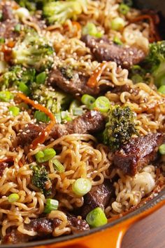 a close up view of some food with broccoli and noodles on it,