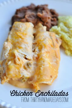 an enchilada on a plate with other food items