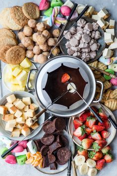 an assortment of desserts and sweets arranged in a circle on a table with utensils