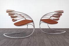 a pair of chairs sitting on top of a wooden floor