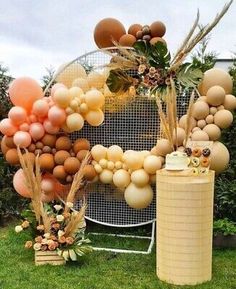 an outdoor birthday party with balloons, cake and desserts on the grass in front of a sign that says happy birthday