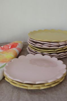 a table topped with lots of plates next to each other