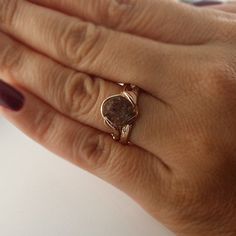 a close up of a person's hand with a ring on their finger,