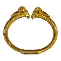 This Vintage Kenneth Jay Lane Rams Head Gold Clamper Bracelet is a traditional piece of vintage jewelry that will go with anything, day or night. The detail on the heads of the ram and the "coiled" design of the bangle make this a clamper bracelet a true standout!  Dimensions: 2.75"L x 2.5"W x .5"D Condition: Excellent vintage condition; very little wear. Please see pics for details. Marks: KENNETH © LANE  About Kenneth Jay Lane: For nearly 60 years, Kenneth Jay Lane (April 22, 1932 – July 20, 2017) was one of the most famous costume jewelry designers in the world. Lane was named, “the undisputed King of Costume Jewelry” by Time Magazine. Lane was friends with, beloved by, and worn by celebrities, royals, first ladies, and socialites such as Jackie Kennedy, Babe Paley, Elizabeth Taylor, Th Babe Paley, Sapphire Bangle, Modern Bangle, 18k Gold Bangle, Rams Head, Red Bangles, First Ladies, Plastic Bangles, Ram Head