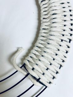 a white and black knitted object sitting on top of a table