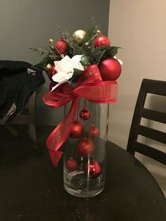 an image of a vase with christmas decorations on the table in front of a cell phone