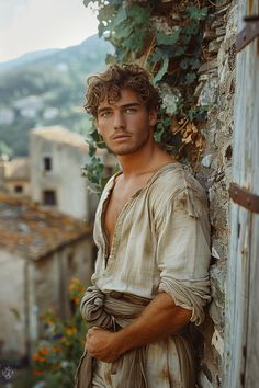 a young man leaning against a wall with his arms wrapped around the back of it