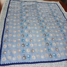 a blue and white blanket on top of a wooden table