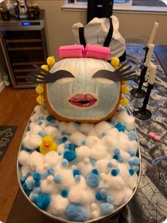 a cake made to look like a woman's face in the bathtub with bubbles