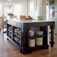 a kitchen island with plates and bowls on it