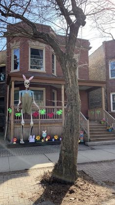 a house decorated for halloween with an inflatable bunny standing on the front porch