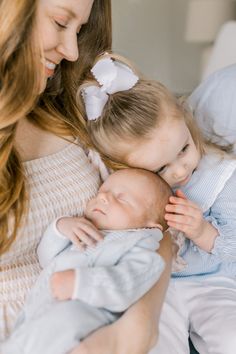 a woman holding a baby in her arms