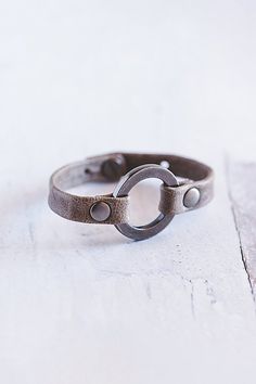 Designed to remind us that we all need to reconnect and ground to nature, our Grounding bracelet is handcrafted from the softest lamb leather and features a chunky antique silver ring with matching rivets. **Contents** * Lambskin leather, zinc alloy hardware * Button clasp closure * Handmade **Care/Import** * Made in the USA **Dimensions** * Adjustable to fit wrist sizes 6.5”-8” | Giving Bracelets Antique Silver Grounding Leather Bracelet at Free People in Grey Antique Silver Rings, Lambskin Leather, Rivets, Zinc Alloy, Antique Silver, Leather Bracelet, Silver Ring, Jewelry Bracelets, Jewelry Accessories