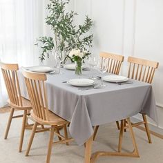 a dining room table set with place settings