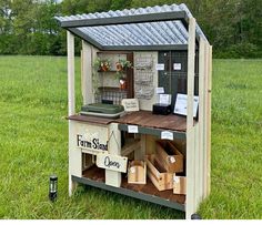 an outhouse made to look like a farm store with lots of items on it