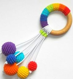 multicolored crocheted wooden teethpick toy with six balls on it