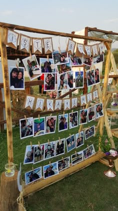 a wooden frame with pictures hanging from it's sides and photos pinned to the side