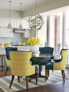 an article in the home decor and design magazine shows a dining room with yellow chairs