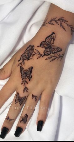 a woman's hand with butterflies on it