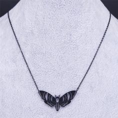 Add some flutter with this moth pendant! Perfect for the fashion-forward individual who isn't afraid to stand out. Available in black, and silver stainless steel options - because every moth has a unique style. Necklace Material: Stainless Steel Length: 19.7 inches Black Stainless Steel Clavicle Chain Necklace, Black Butterfly Charm Jewelry, Black Butterfly-shaped Jewelry For Gift, Black Butterfly Jewelry For Gift, Black Butterfly Necklace For Gift, Black Stainless Steel Necklace, Gothic Moth, Moth Pendant, Fade Color