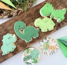 decorated cookies sitting on top of a wooden board