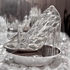 a pair of high heeled shoes sitting on top of a metal tray covered in crystal crystals