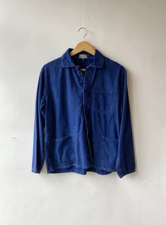 Over-dyed cotton French workwear jackets. A super cool closet staple that's somewhere between a shirt and a jacket (a shacket if you will) with easy access pockets. Estimated to be from the 60s/70s. Please note: Each one is unique and varies slightly in color and style; some are thicker while others are softer and more worn-in. If you have a specific preference, add a note to your order upon checkout and we will do the best to accommodate your request. These sizes are Unisex in sizing. Approx. M Casual Pre-washed Cotton Outerwear, Everyday Washed Blue Long Sleeve Outerwear, Indigo Long Sleeve Outerwear With Buttoned Pockets, Vintage Long Sleeve Shacket With Patch Pockets, Oversized Vintage Cotton Utility Jacket, Everyday Washed Cotton Utility Jacket, Relaxed Fit Cotton Utility Denim Jacket, Relaxed Fit Washed Utility Jacket For Everyday, Washed Blue Long Sleeve Tops With Patch Pockets