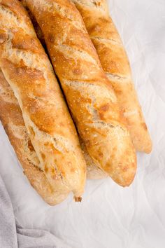 two loaves of bread sitting on top of white paper