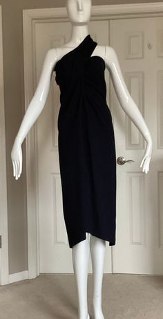 "This is a classic and iconic Romeo Gigli garment from 1992. It is black crepe wool and can be worn as a dress or a skirt.  Every Gigli collector loves this piece as it is so very wearable today either dressed  up or down. In one photo I show it with the matching long sleeve top (in a separate listing). He would have styled this garment with an iridescent silk neck scarf and an over sized cocoon coat. (See my other listings for such a jacket or coat).  This garment is Italian 42, USA 8 The fabric has stretch to it.  Measurements when worn as a skirt: Waist- 28\" Hips - 34\" Length - 40\" Measurements when worn as a dress: Bust - 34\" Waist - 28\" Hips - 37\" Length -39\"" Classic Wool Evening Dress, Formal Fitted Wool Midi Dress, Black Midi-length Halter Dress For Formal Occasions, Black Midi Halter Dress For Formal Occasions, Black Midi Length Halter Dress For Formal Occasions, Black Midi Length Halter Dress For Formal Events, Black Wool Dress For Formal Occasions, Black Wool Dress For Evening, Chic Sleeveless Wool Dress