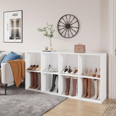 a living room filled with furniture and lots of shoes on the shelf next to it