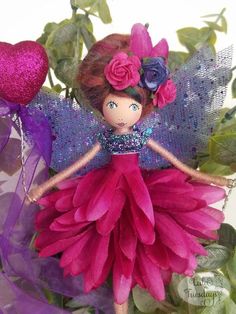 a doll with pink and purple flowers on her body