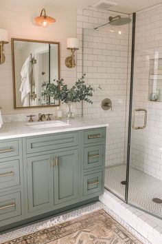 a bathroom with white tile and blue cabinets