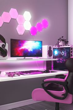 a computer desk with two monitors and headphones sitting on it's side in front of a purple wall