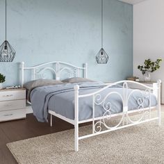 a white metal bed frame in a bedroom