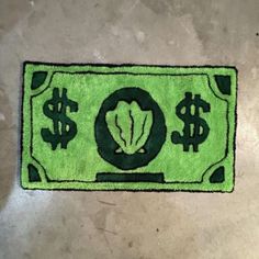 a green rug with dollar signs on it