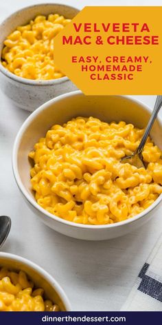 two bowls filled with macaroni and cheese on top of a white tablecloth