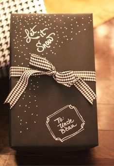 a black and white box with a bow on it