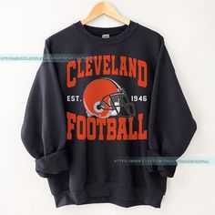 an old cleveland football sweatshirt hanging on a hanger