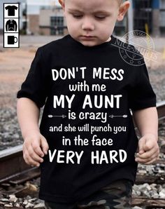 a young boy wearing a black shirt with the words don't mess with me my aunt is crazy and she will punch you in the face very hard