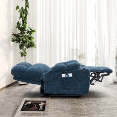 a blue reclining chair sitting on top of a rug