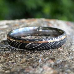 two rings sitting on top of a rock