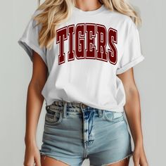 Tigers Varsity T Shirt, Maroon Tigers T Shirt, Tiger Game Day Shirt, Tigers Football Spirit Shirt, Tigers Apparel, Tigers Mom Shirt CARE INSTRUCTION - Turn garment inside out before wash. - Wash with cold water. - Do not dry clean, lay flat to dry. - Do not iron directly on the design. White Slogan T-shirt For College, White College Style T-shirt With Letter Print, White College Style T-shirt With Text Print, School Spirit Short Sleeve Tops With Text Print, Short Sleeve Tops With School Spirit Text Print, Short Sleeve Tops With Text Print For School Spirit, White College Style T-shirt, White School Spirit Shirt With Letter Print, White Shirt With Letter Print For School Spirit