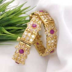 Ruby Pink Polki Bangles/ Golden Ruby Bangles/ Sabyasachi Bangles/ CZ Indian wedding Jewelry/ Pink Polki Punjabi Bangles/ AryaFashions Traditional Ruby Polki bangles Set Handcrafted To Perfection Light Weight Bangles Perfect For Indian Weddings And Celebrations A Beautiful & Memorable Gift for Weddings and Special Occasions Available in 2.6,2.8 size The base metal color is Gold tone brass studded with colorful semi-precious Kemp stones on it. Facebook: www.facebook.com/shoparyafashions Pinterest: Pink Meenakari Bangle For Wedding, Pink Meenakari Wedding Bracelets, Pink Meenakari Wedding Bangle, Pink Cutdana Bangle For Weddings, Pink Wedding Bangle With Cutdana, Kundan Bracelets With Zari Work For Wedding, Traditional Bangle For Reception And Festivals, Chandbali Wedding Bracelets With Zari Work, Pink Stone Work Bangle For Wedding