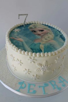 a frozen princess cake with the number seven on it