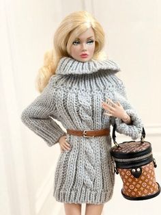 a barbie doll wearing a gray sweater dress and holding a brown purse